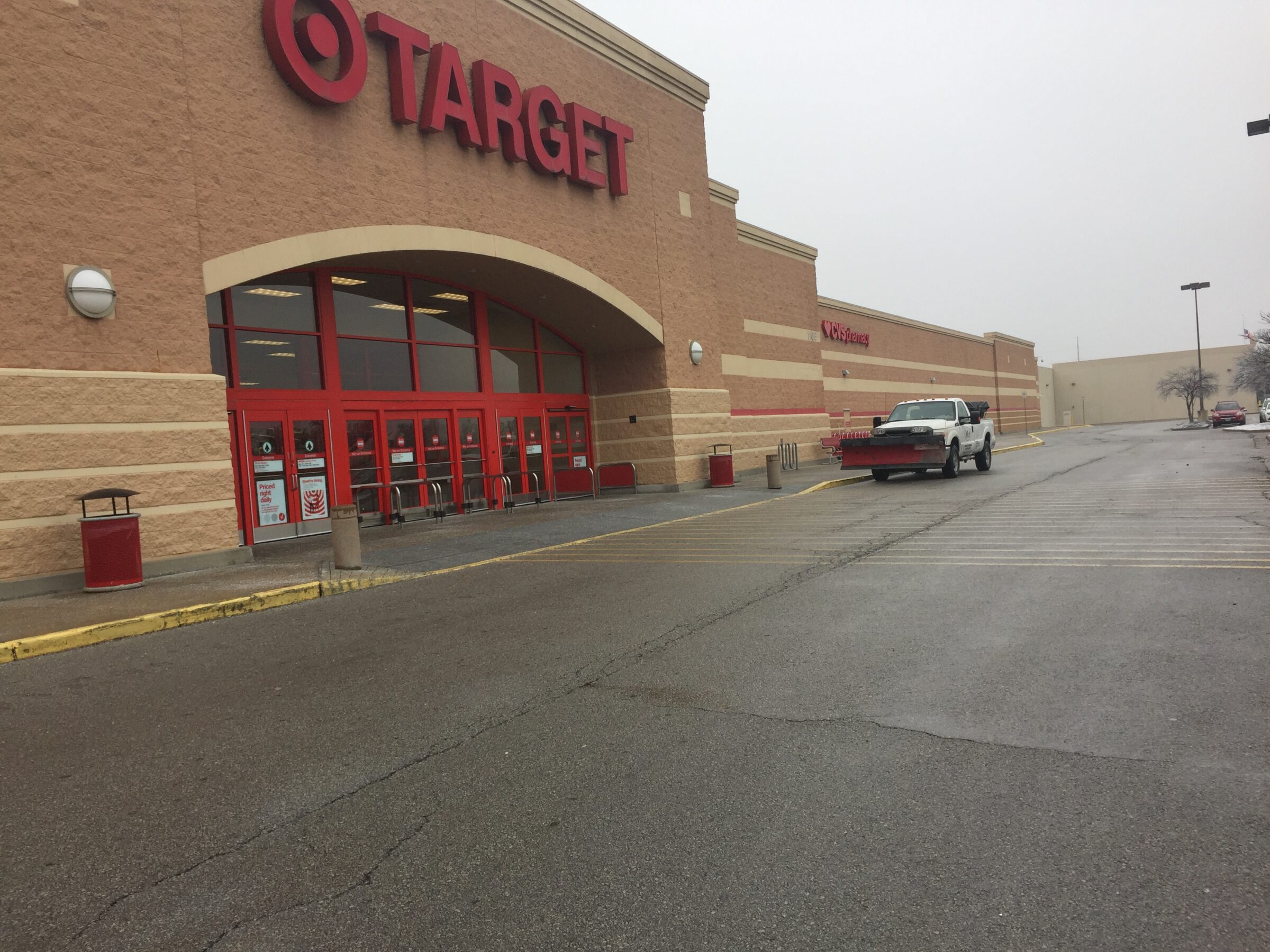 Large Target store exterior with a parking lot featuring a white truck. Overcast sky. No people are visible in the image.